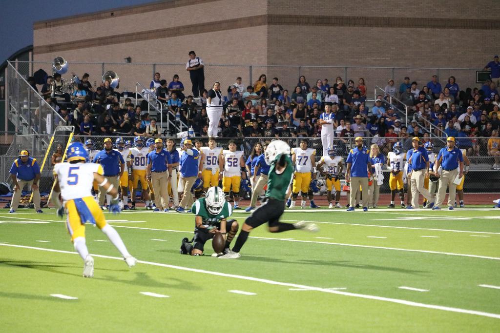 A football player prepares to catch a pass, demonstrating focus and athleticism on the field.
