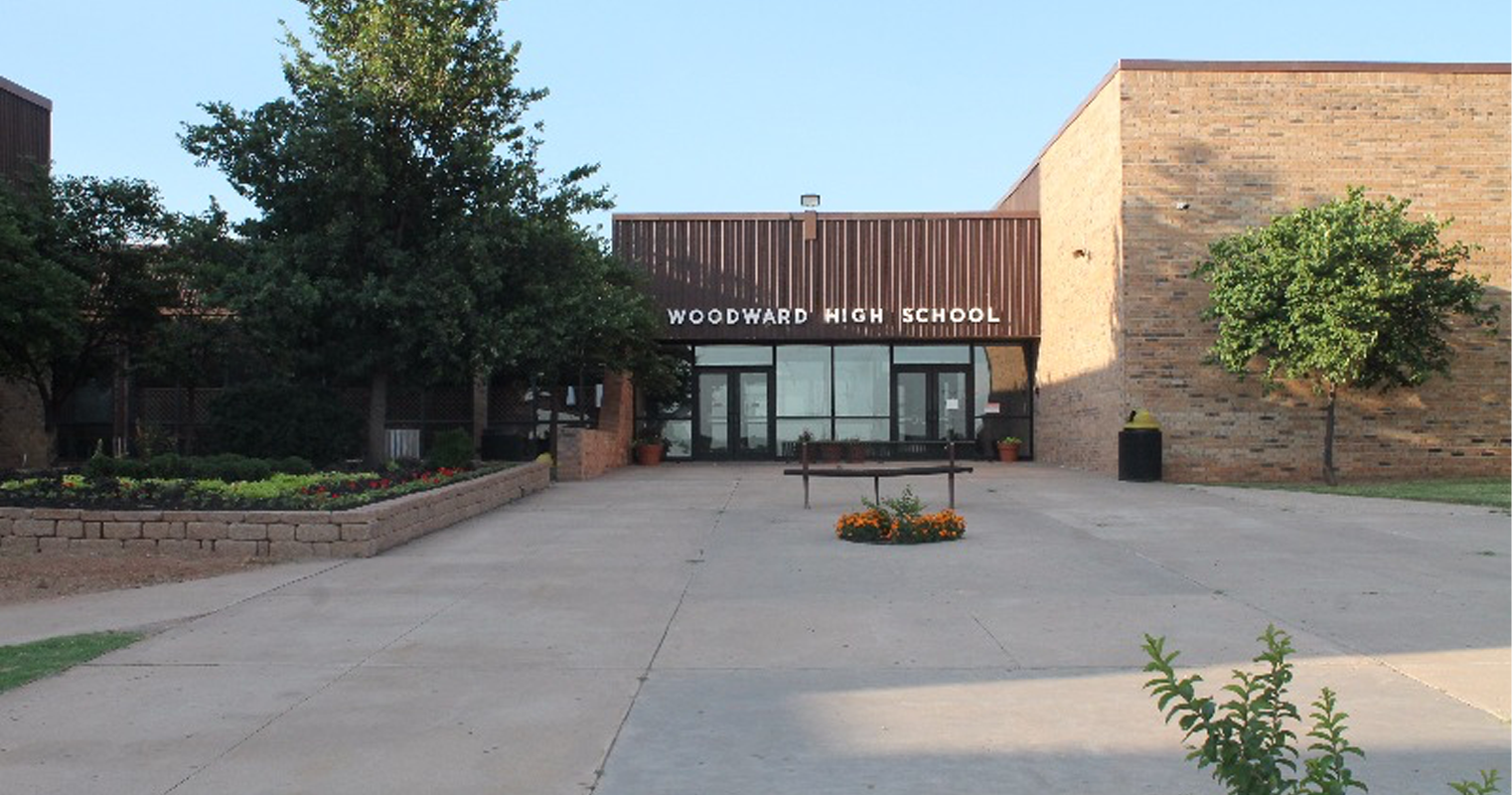 The front entrance of the school, featuring doors and windows, is prominently displayed in the image.