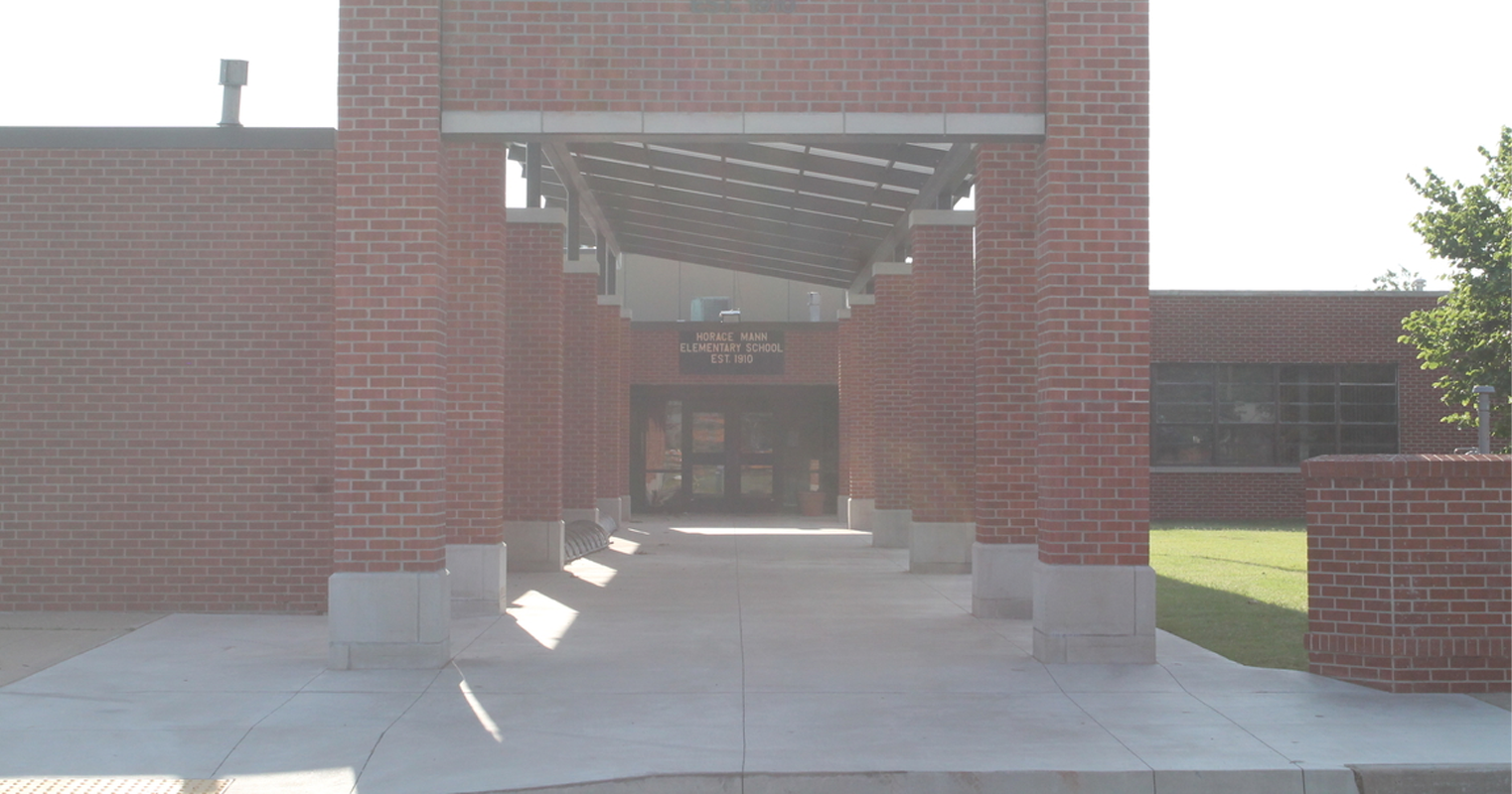 A brick building featuring a prominent large archway, showcasing classic architectural design and sturdy construction.