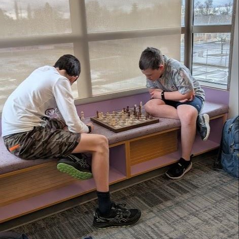 Two students playing a game of chess
