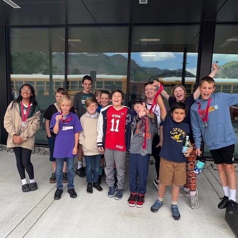 Students showing off their award medals