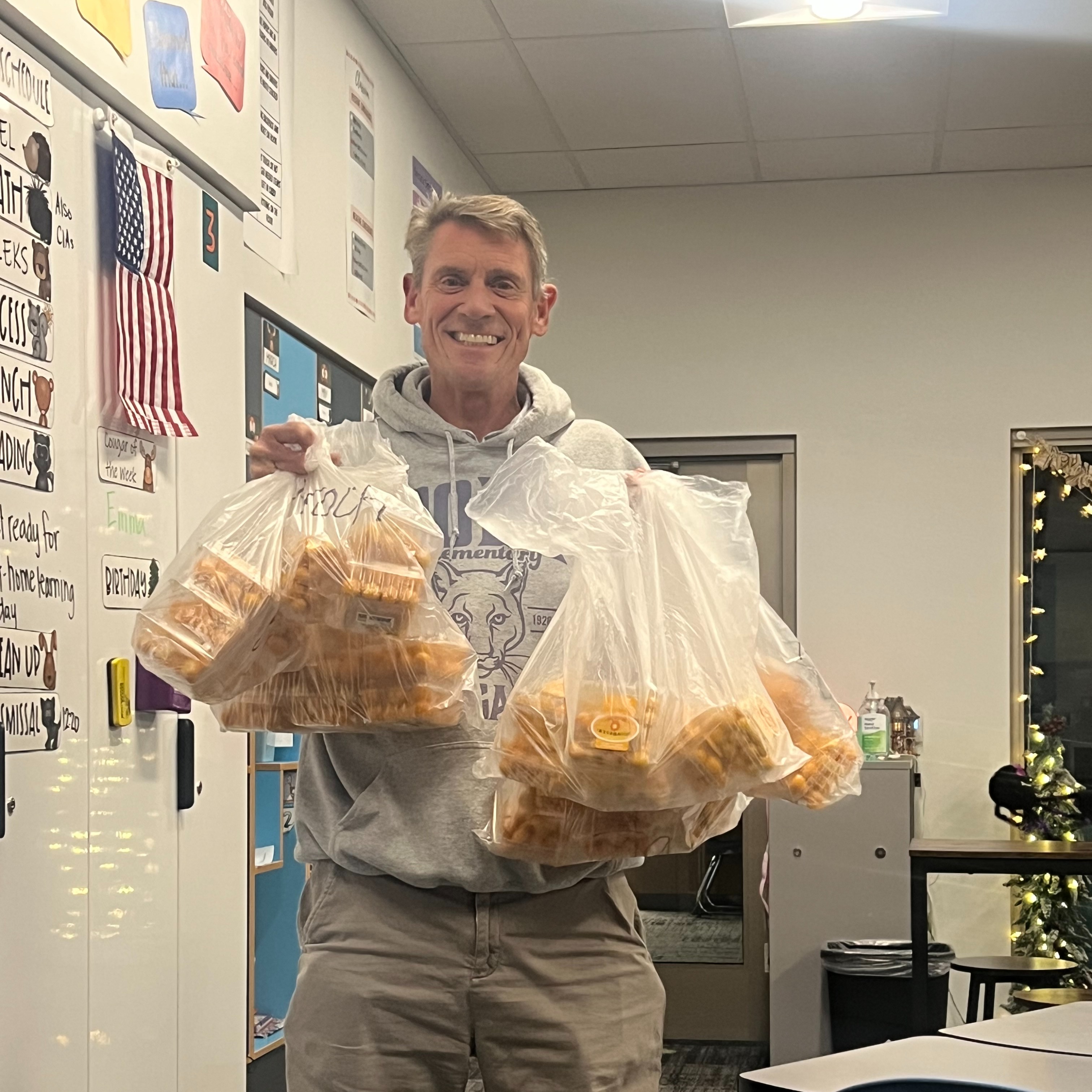 Mr. Edwards holding bags of gooseberries