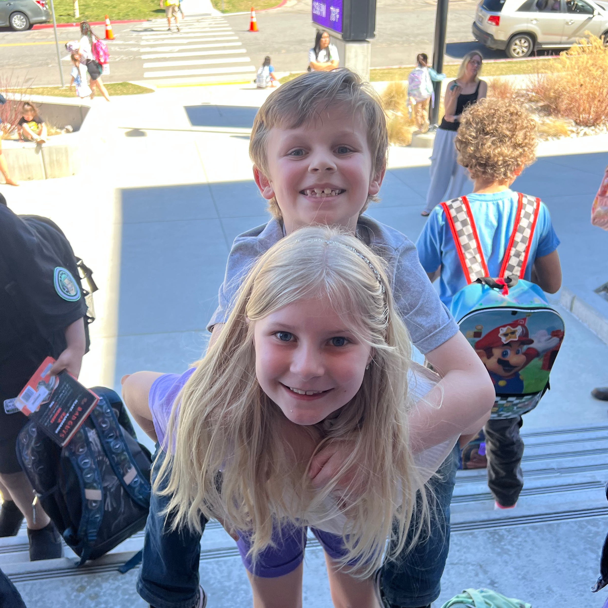 Two students giving each other a piggy back ride