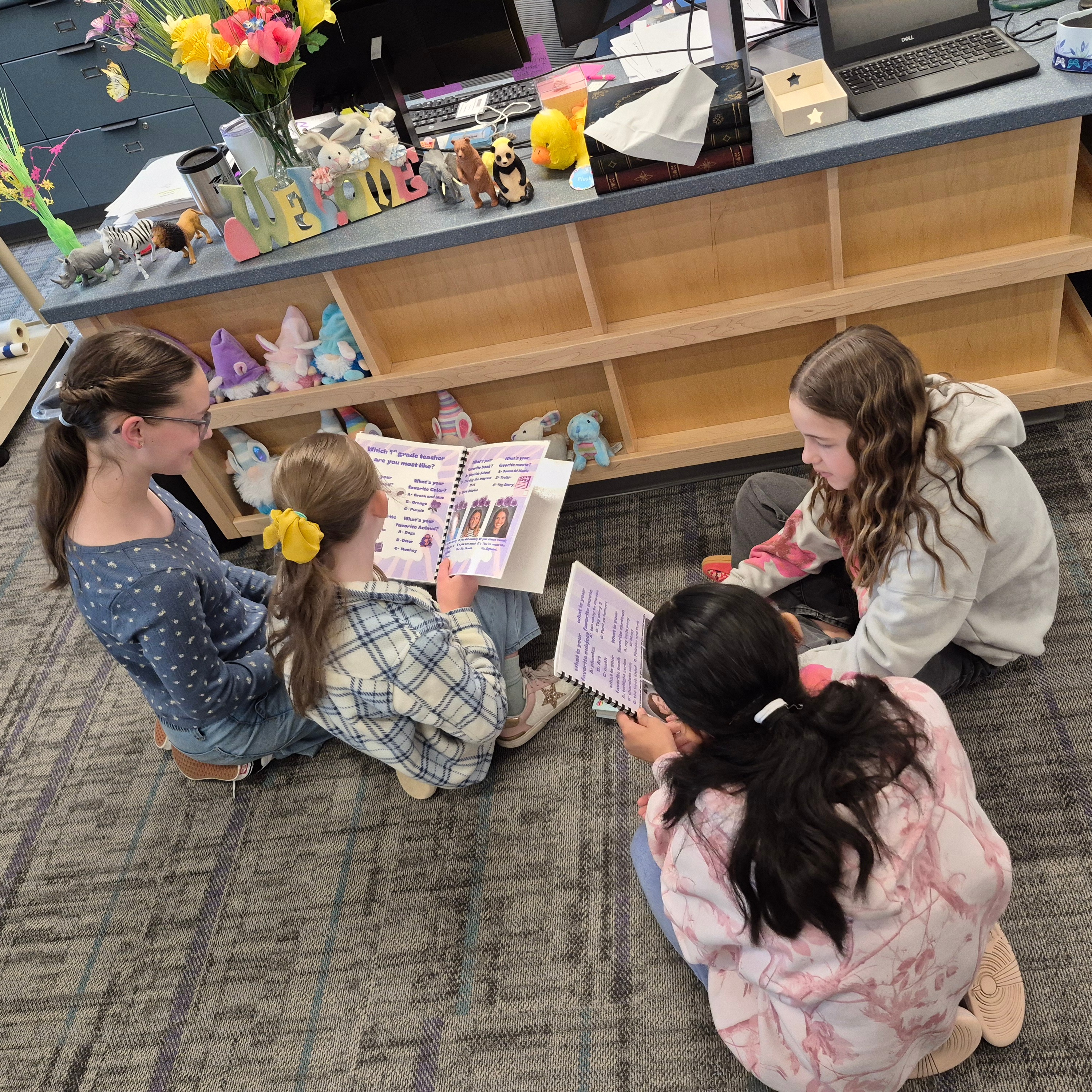 Studnents sitting on the floor reading together.