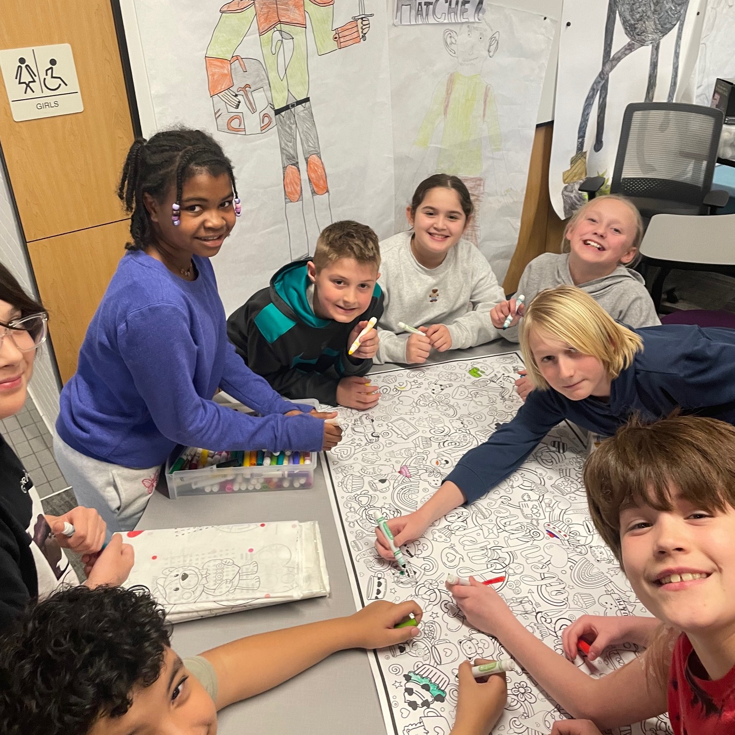 group of students working on a large coloring page