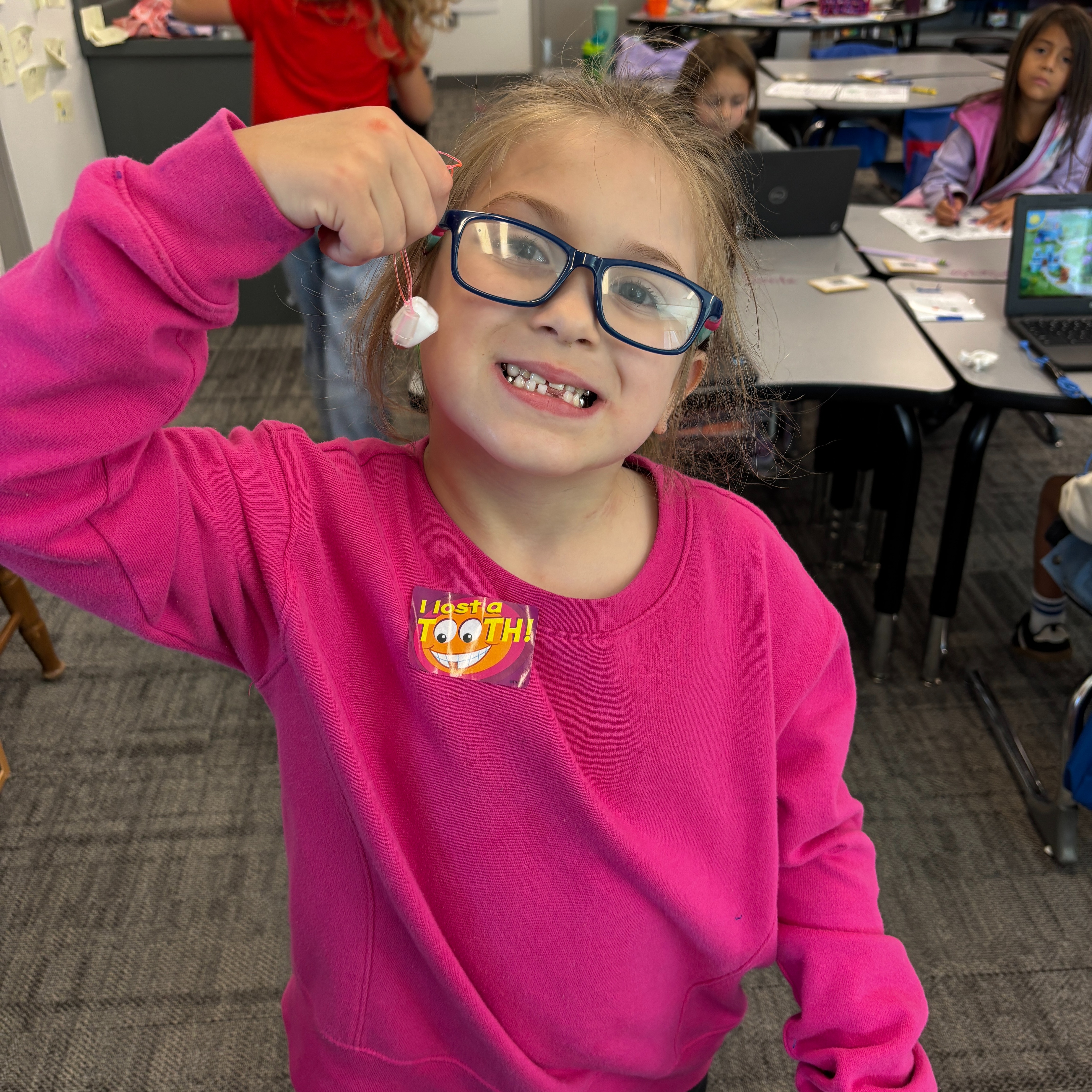 student with a tooth necklace because they lost a tooth 