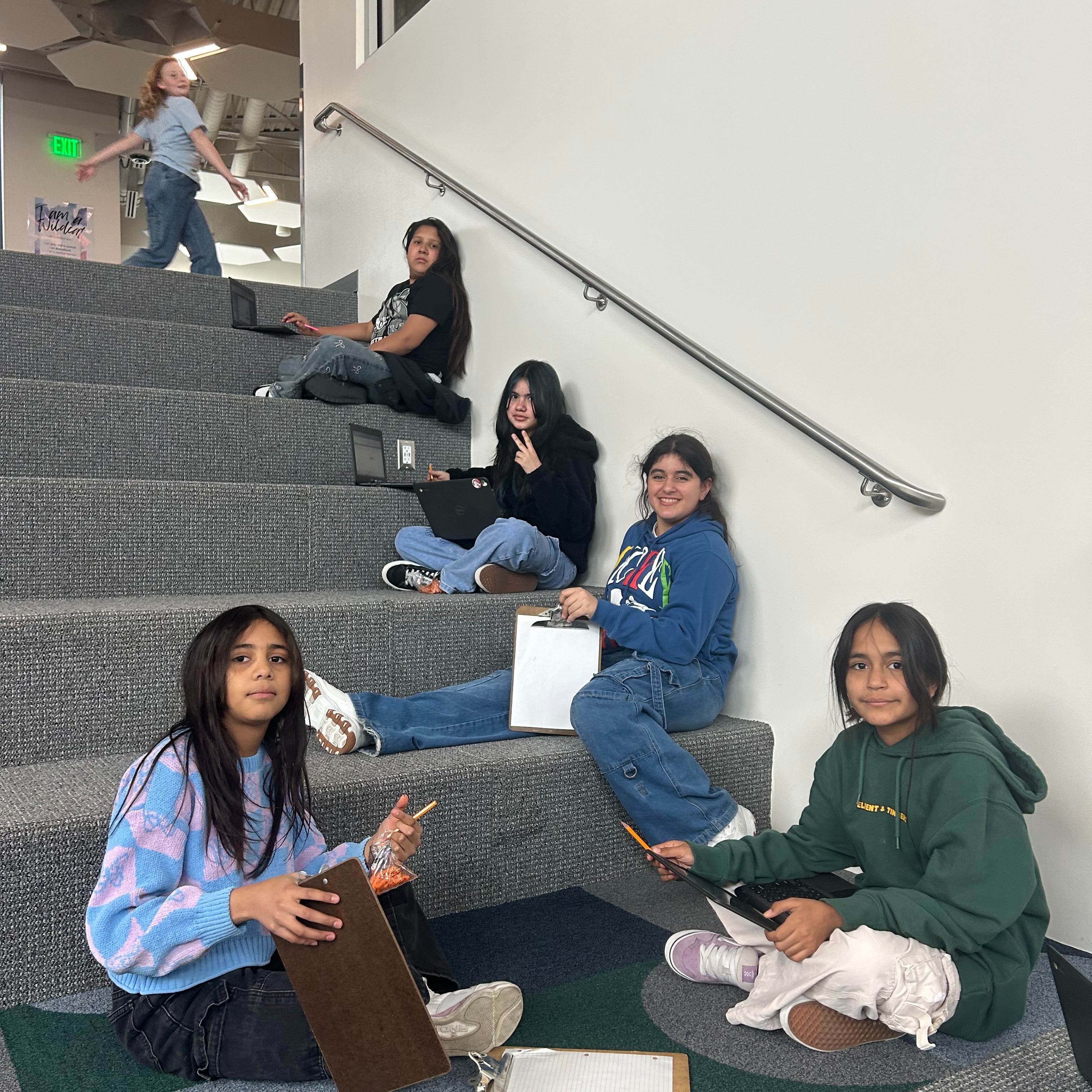 Students sitting on learning stairs