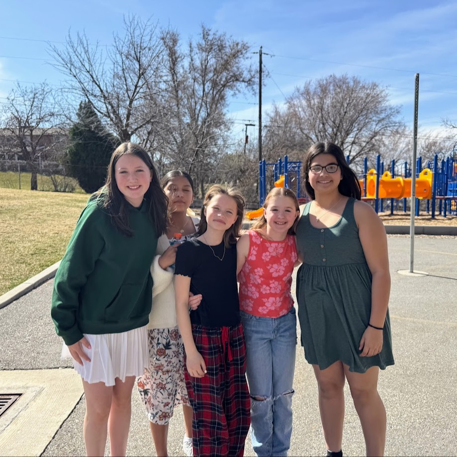 4 6th grade girls outside on the playground