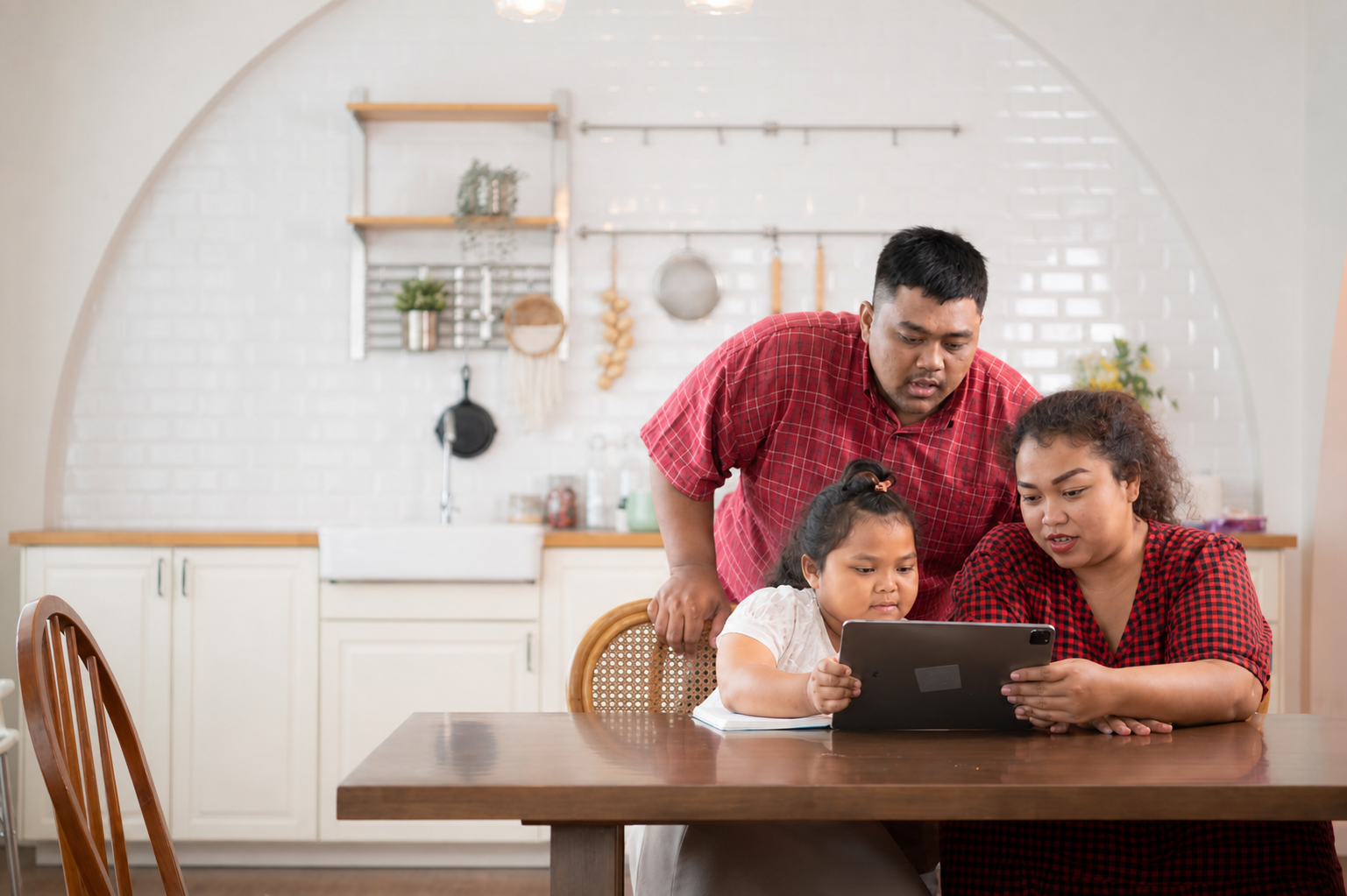 Family using iPad for online school registration