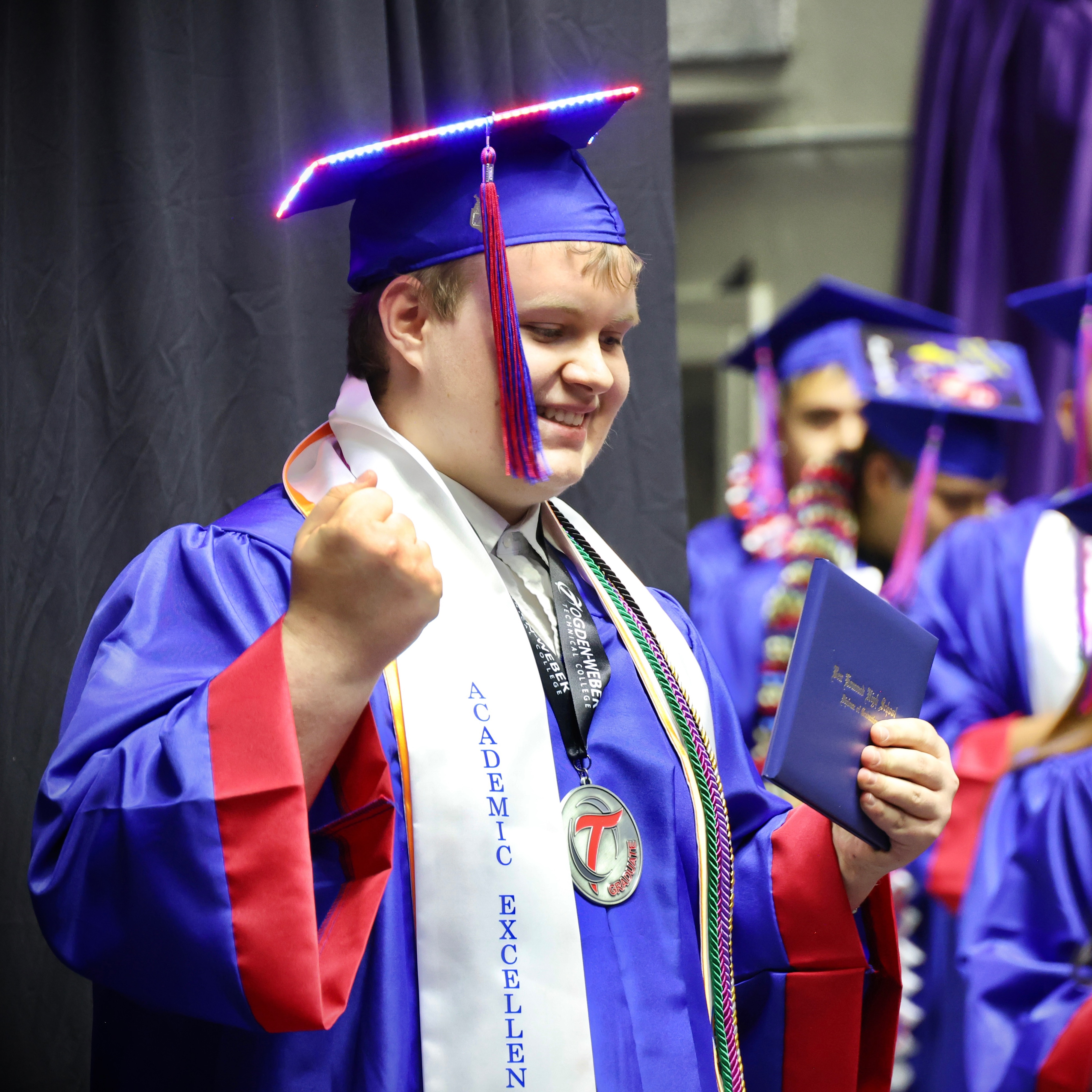 Graduate with college completion medallion