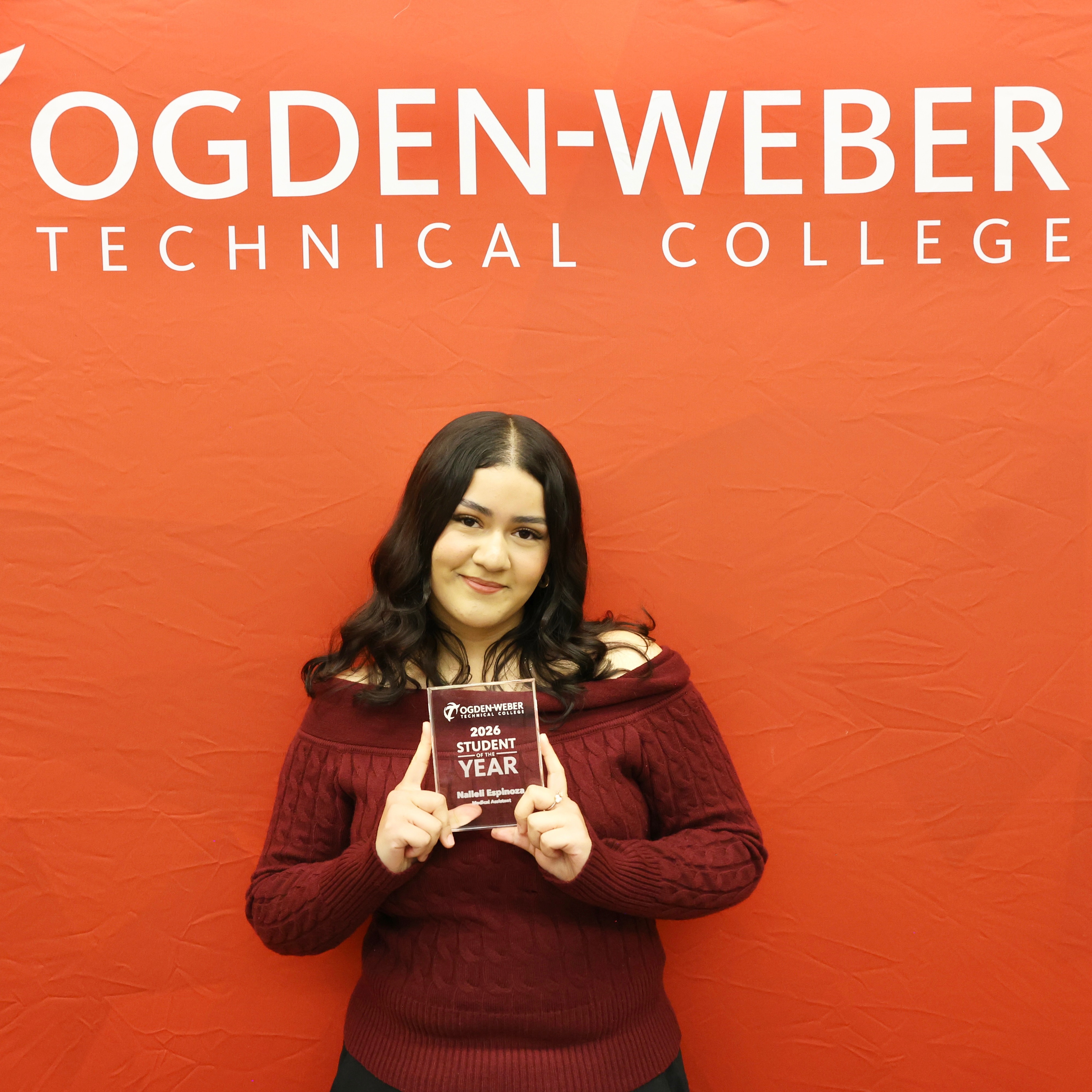 Student Holding Award