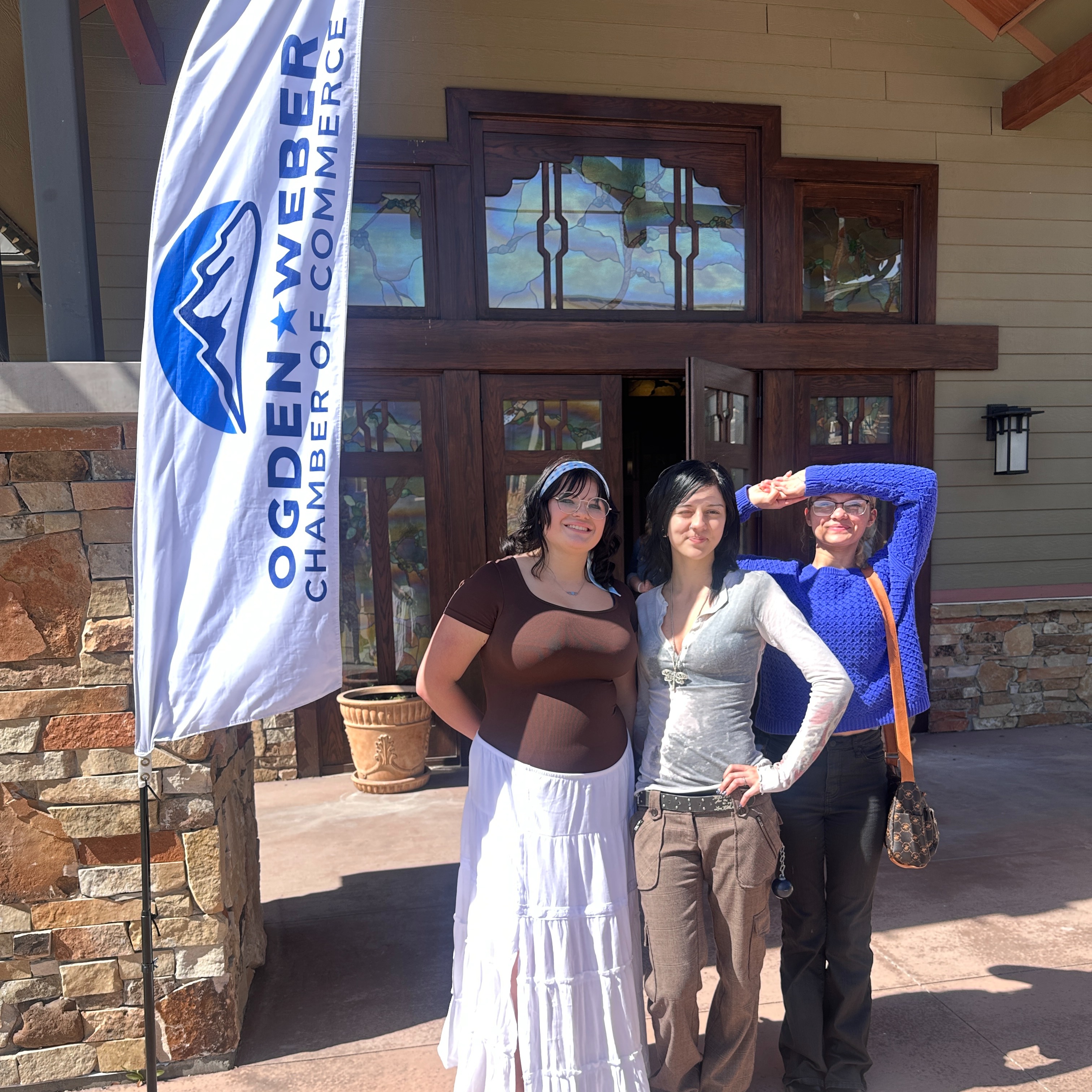 Three students at a women in business luncheon 