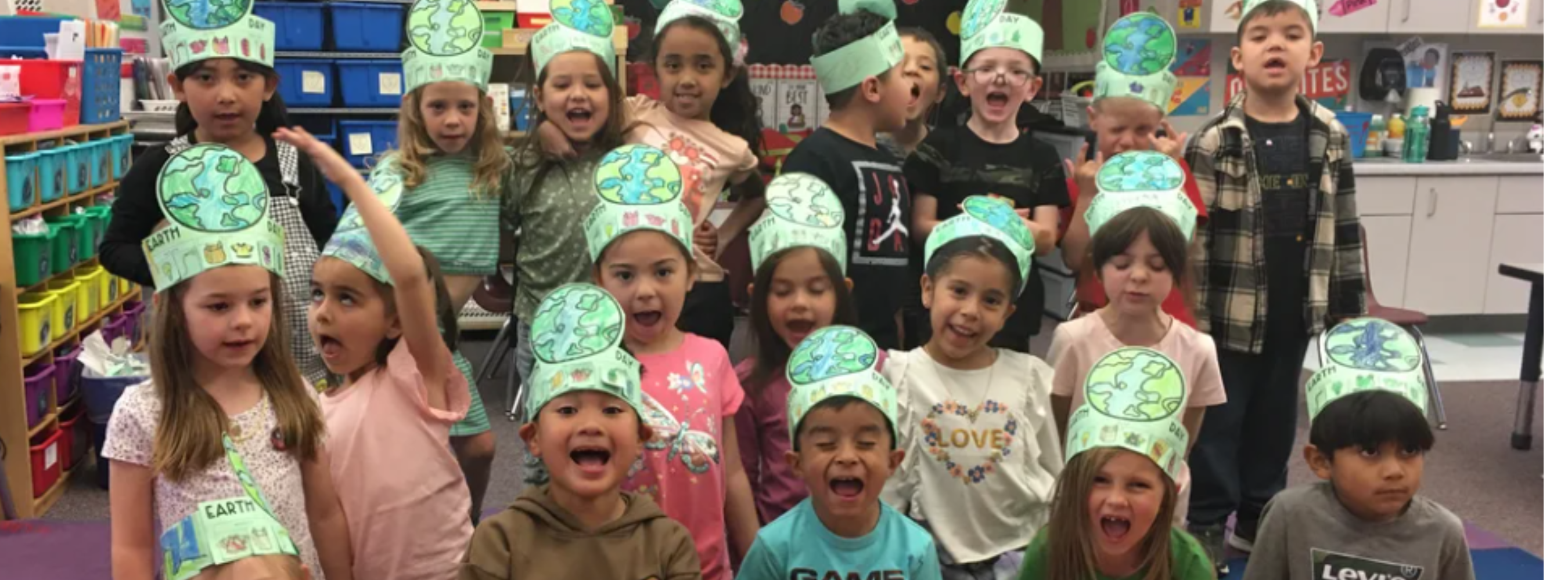 Kindergarten students wearing Earth Day hats