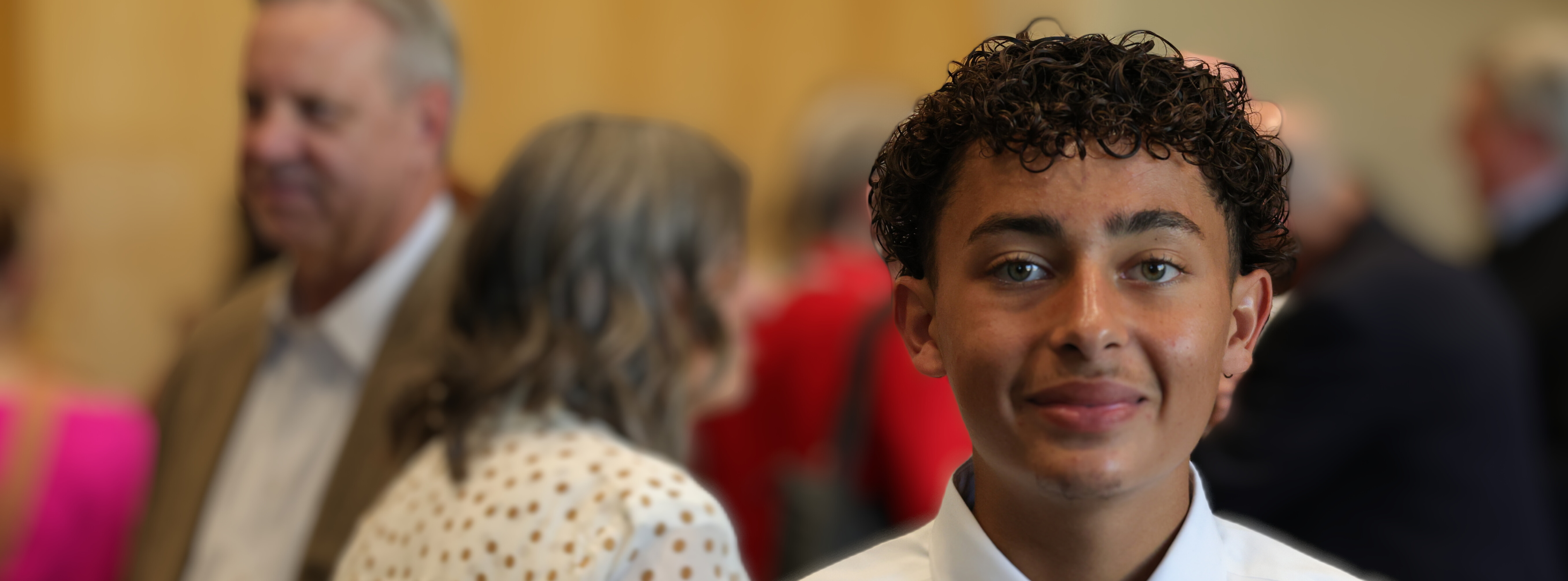 student looking into camera with blurred background