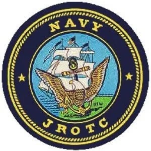 An emblem featuring a ship and an eagle, surrounded by the text 'NAVY JROTC' on a circular background.