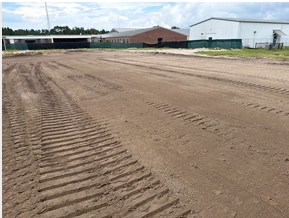 Construction site at Wakulla High School showing graded dirt, tire tracks, fencing and equipment near the future building area as Phase 1 construction continues.