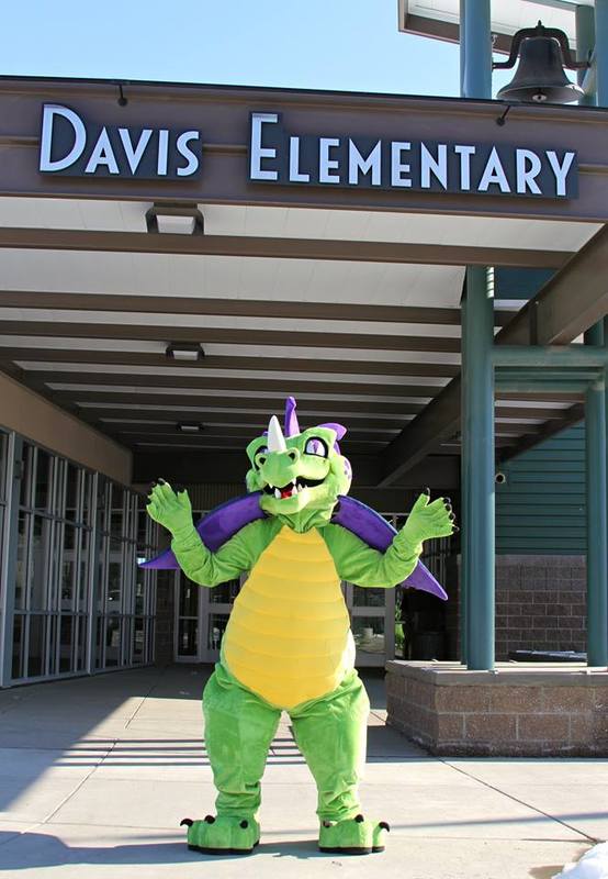 A photo of the Davis mascot in front of the school building