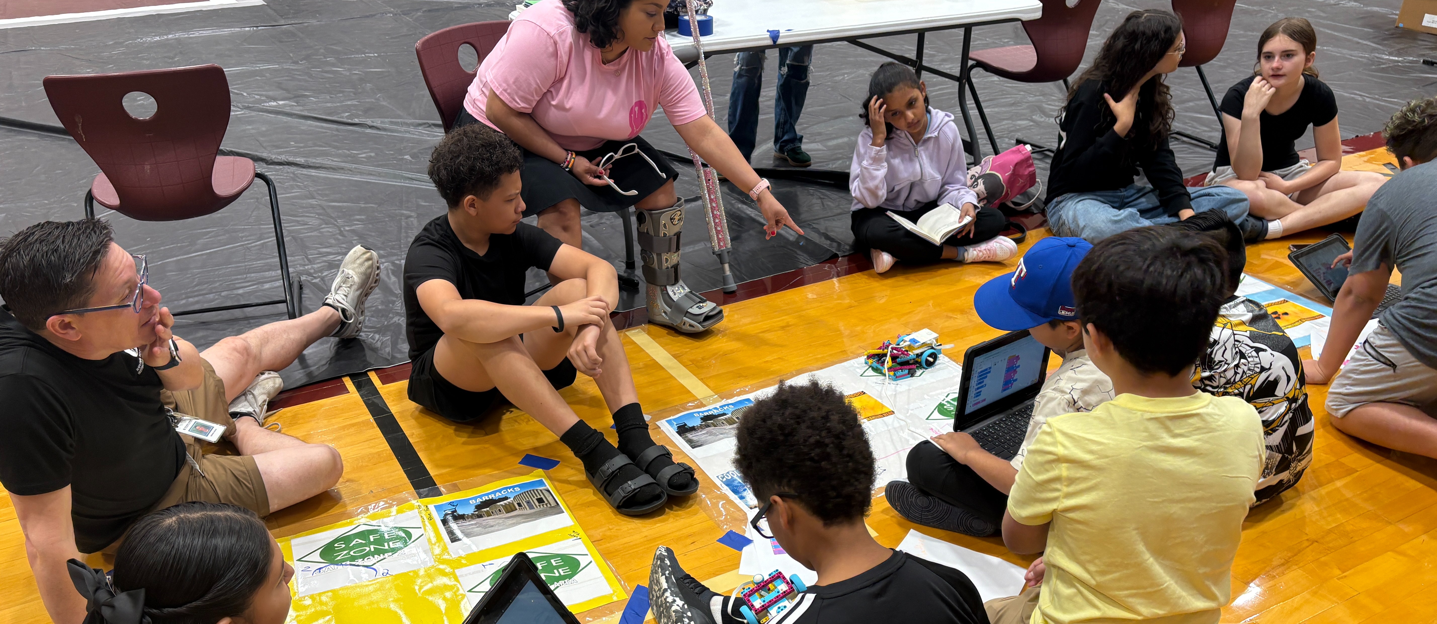 Decorative Image with a group of students working with Lego Robotics at Round Rock ISD's robotics symposium.