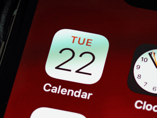 A smartphone displaying the current time and date on its screen.