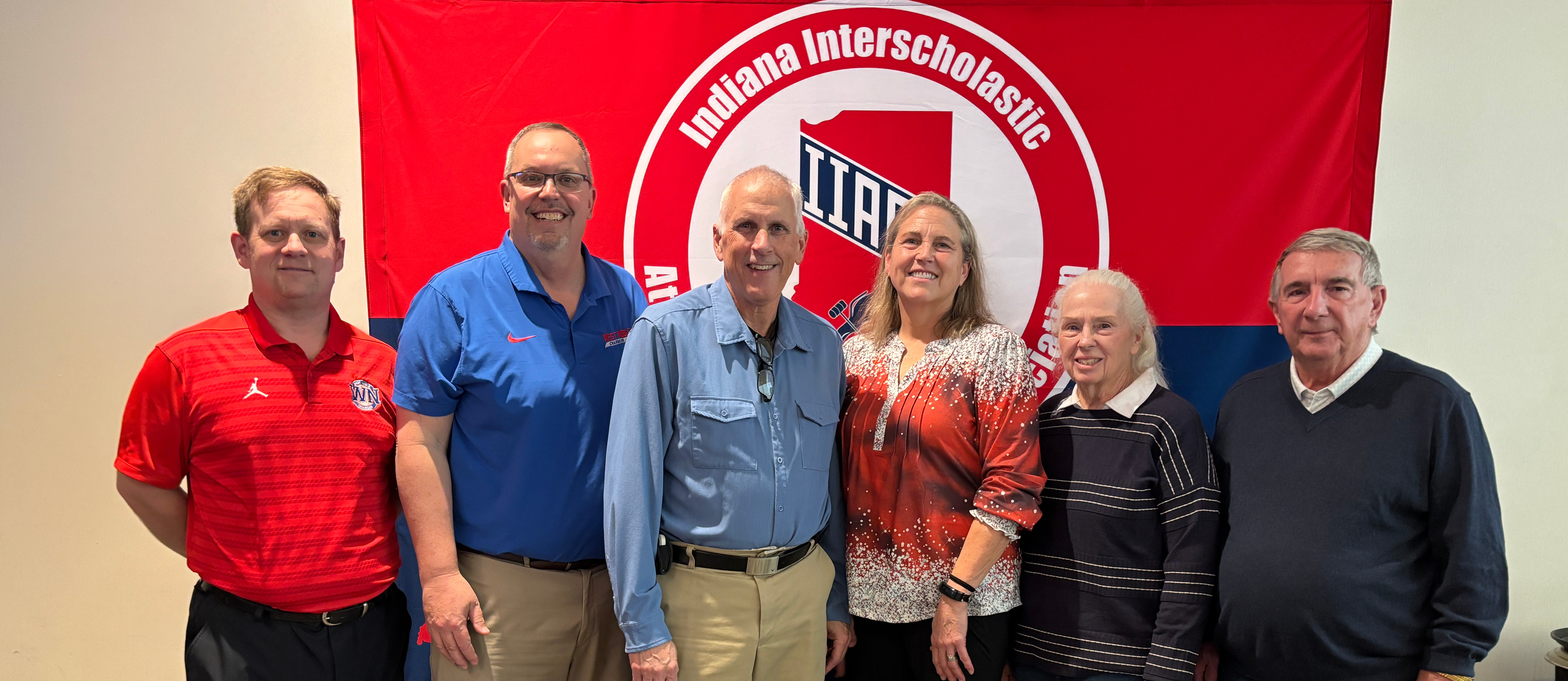 the younce family posing with their friends at an awards banquet