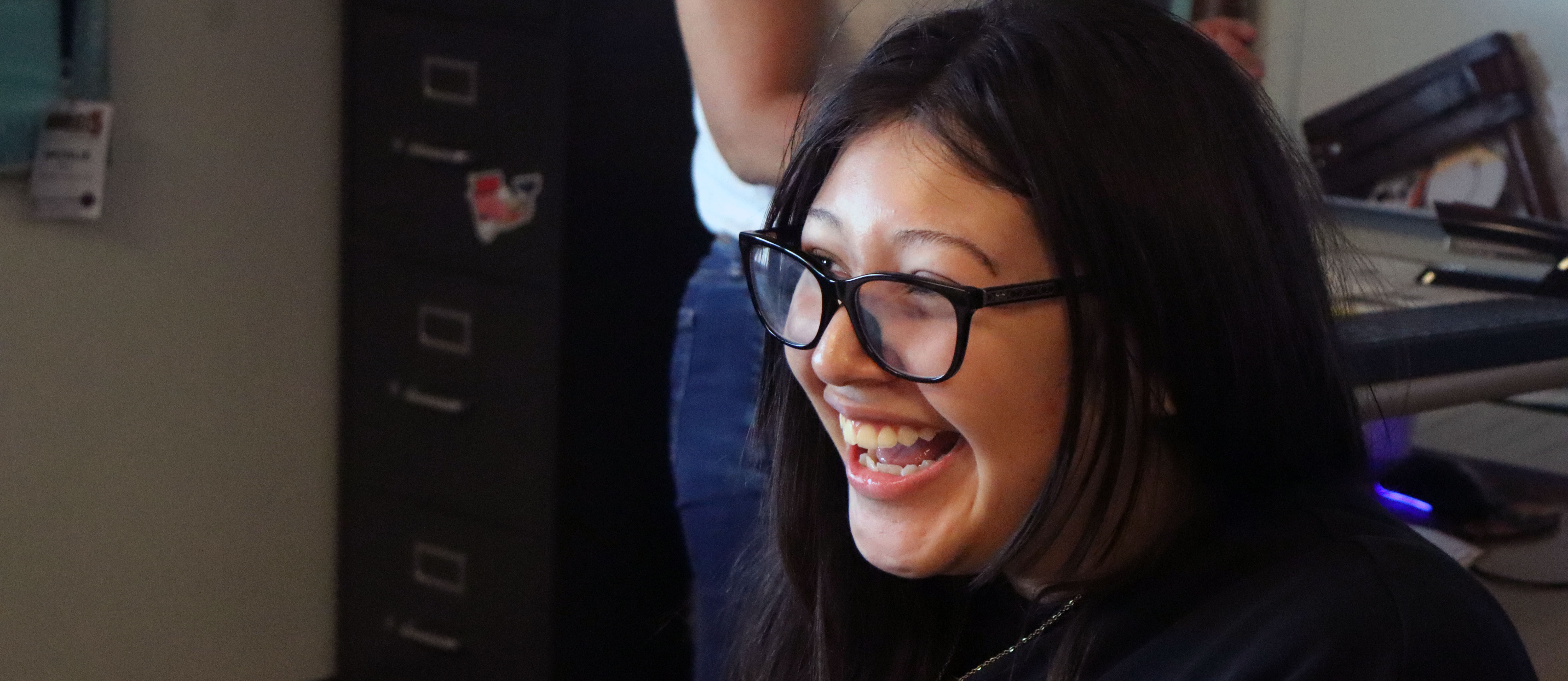 A girl with glasses laughing