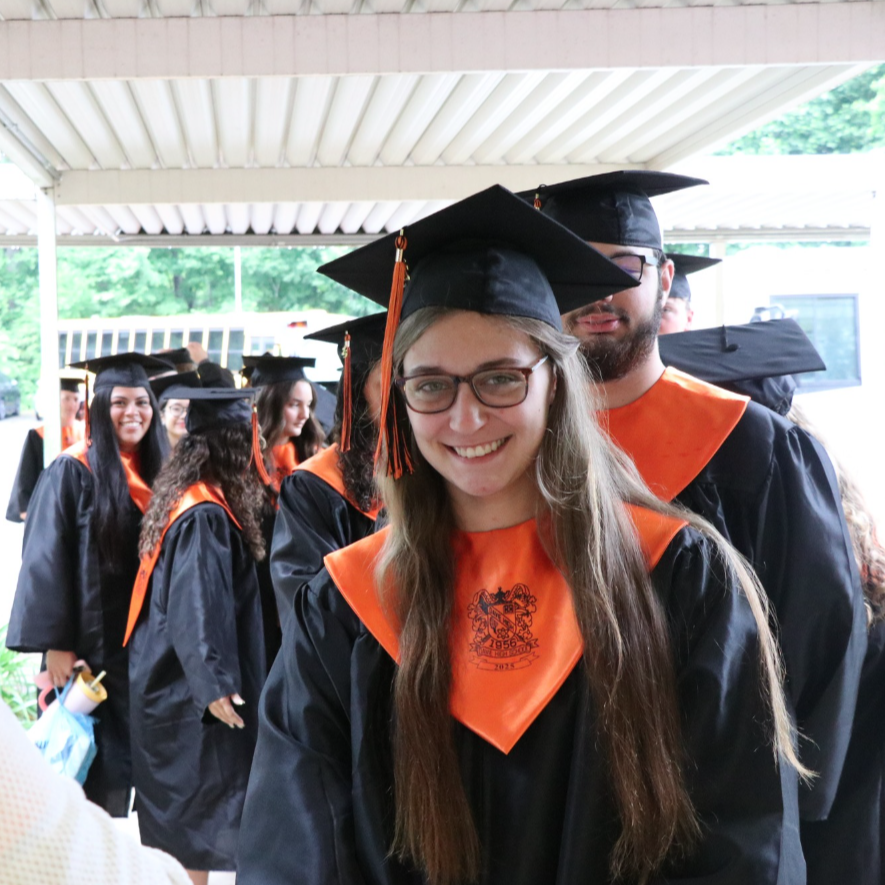 Students dressed in cap and gown, walking