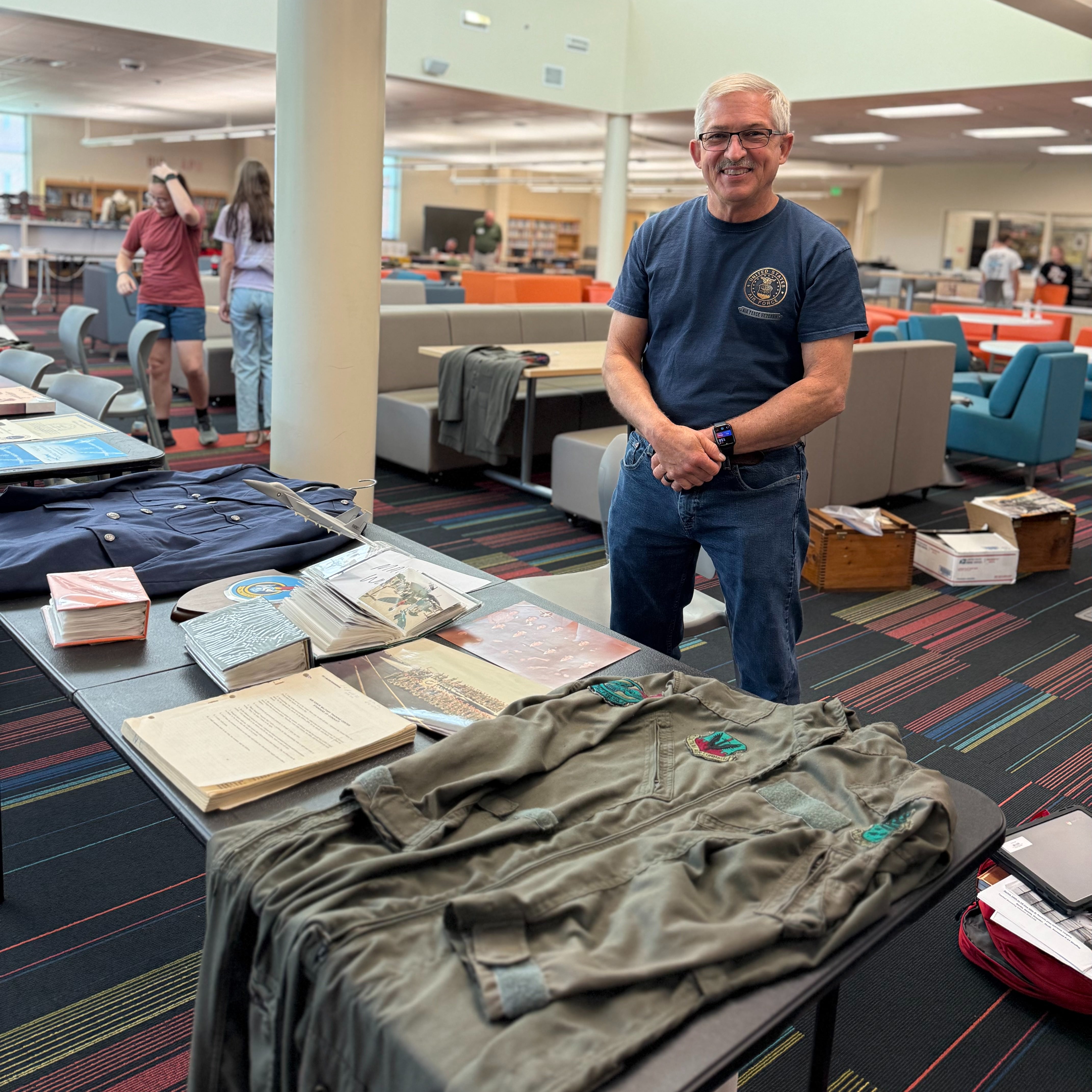 Mr. Wood, veteran, showcasing pictures taken abroad. 