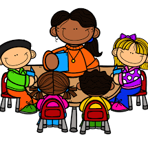 A teacher and students engaged in discussion around a table, illustrating a collaborative learning environment.
