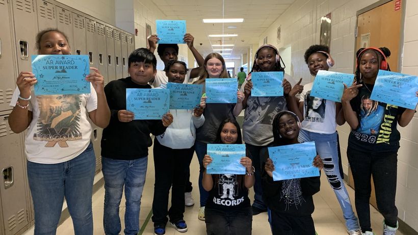 zzStudents proudly display their certificates at school, celebrating their achievements and hard work.