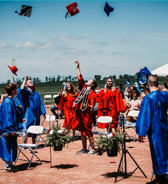 A diverse group of graduates proudly wearing their graduation robes, celebrating their academic achievements together.