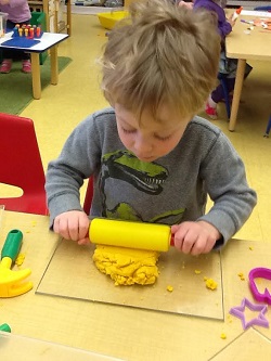 Kid playing with clay