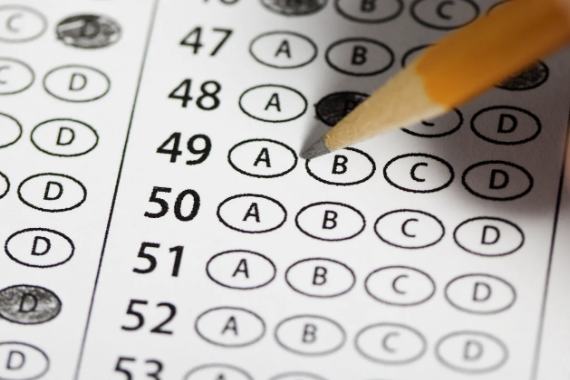 stock image of testing paper being filled out with pencil 