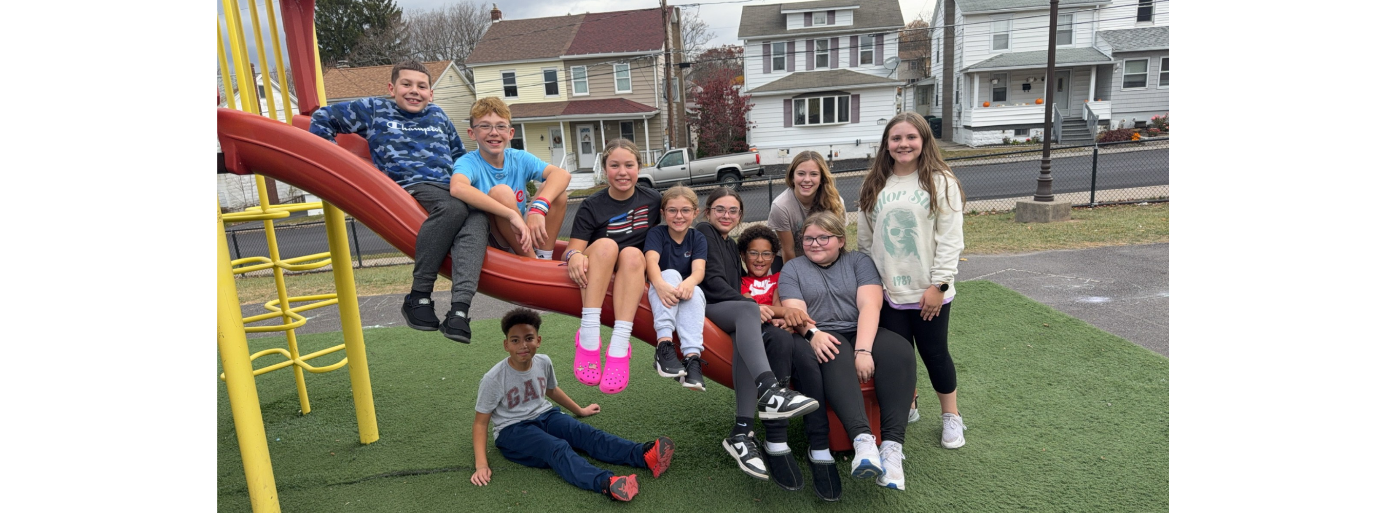 students outside on a slide together 