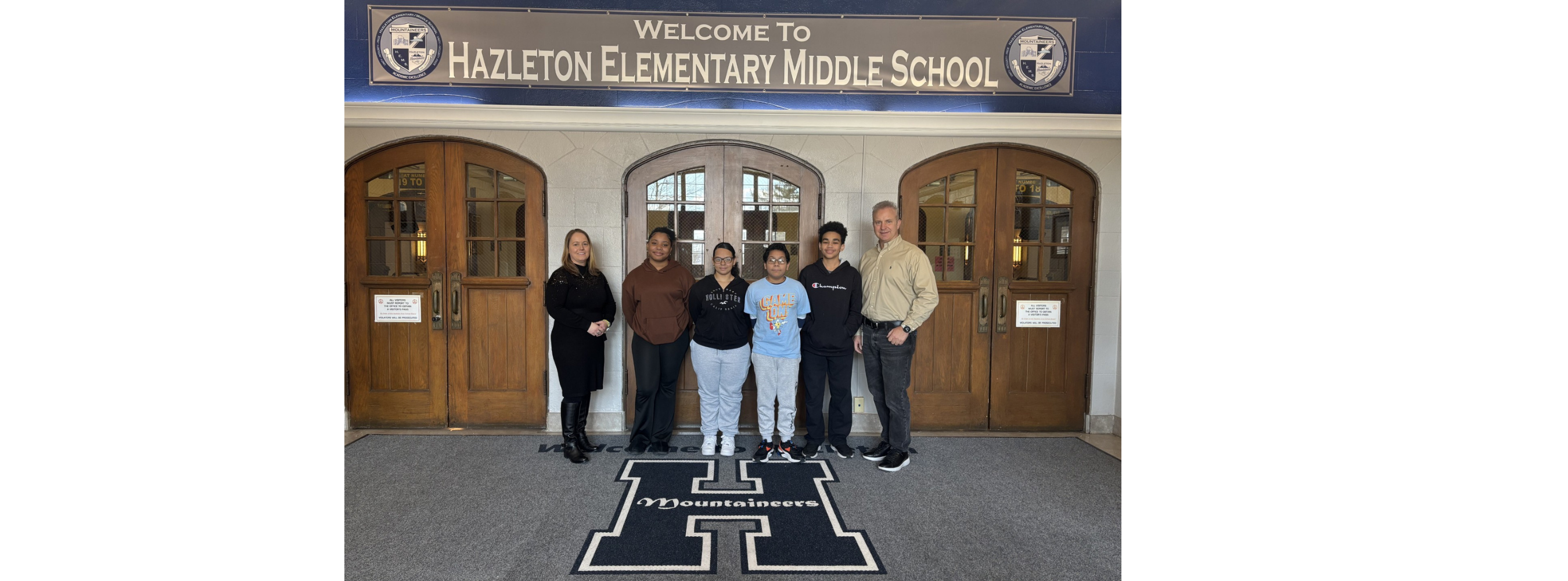 students standing in front of the front entrance 