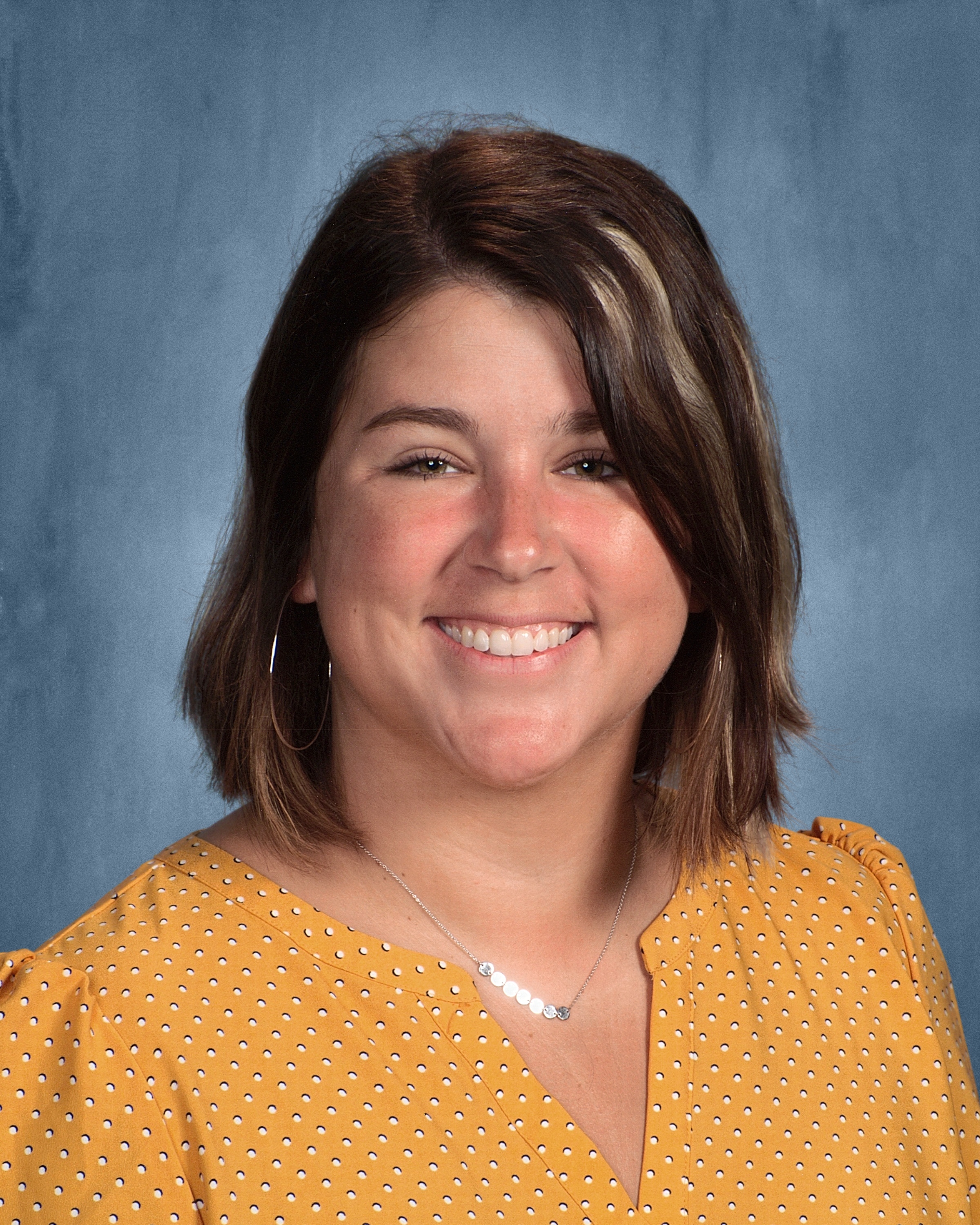 Photo of Elizabeth Macklin on a blue background