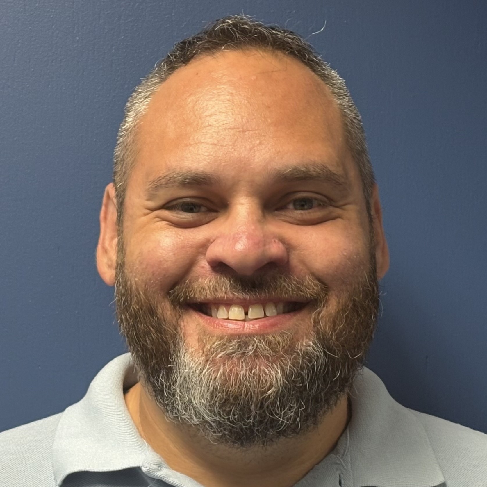 Bearded man smiling. That man is Jared Swiger