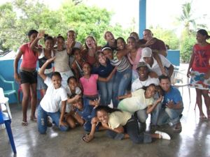 cheerful gathering of people standing together, posing for a photo in a spacious indoor setting.