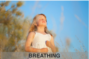 girl outside with eyes closed breathing