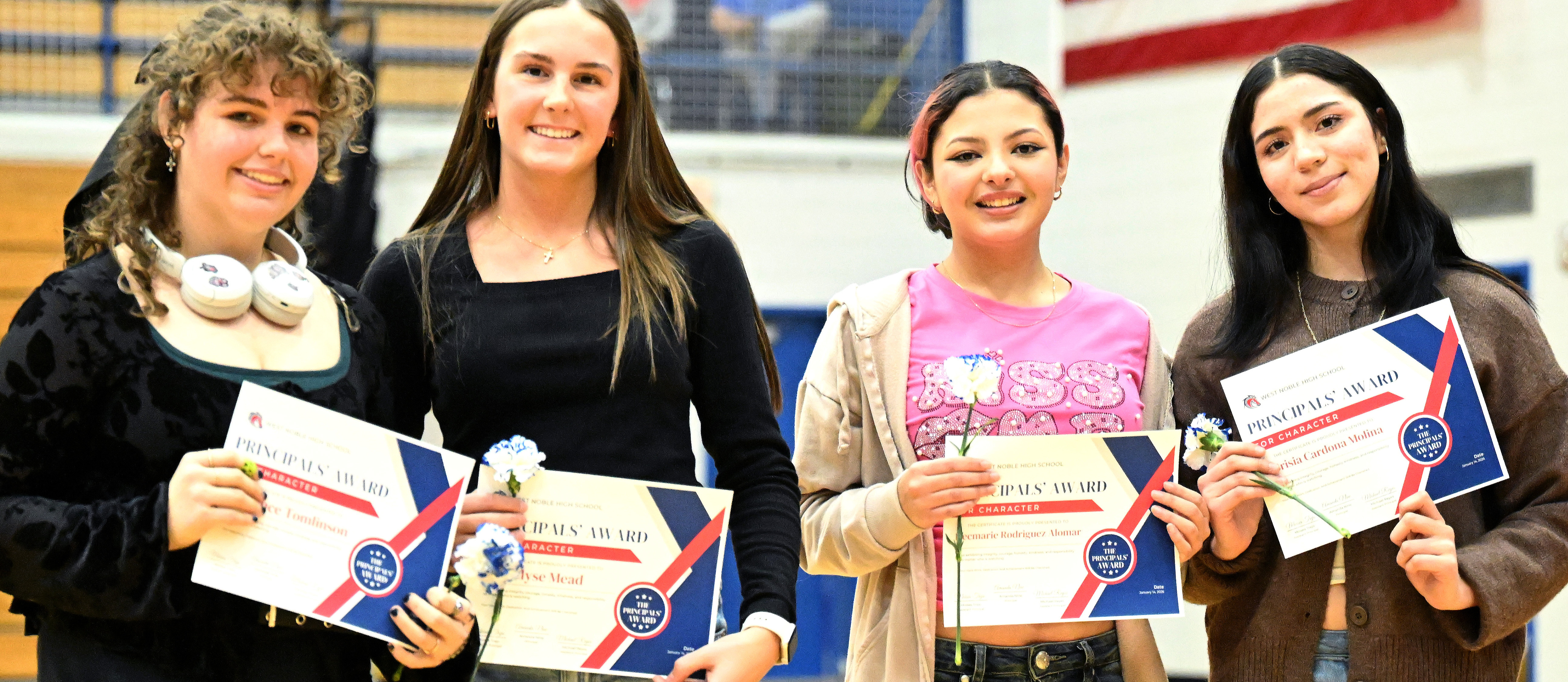 female students with their high school class awards