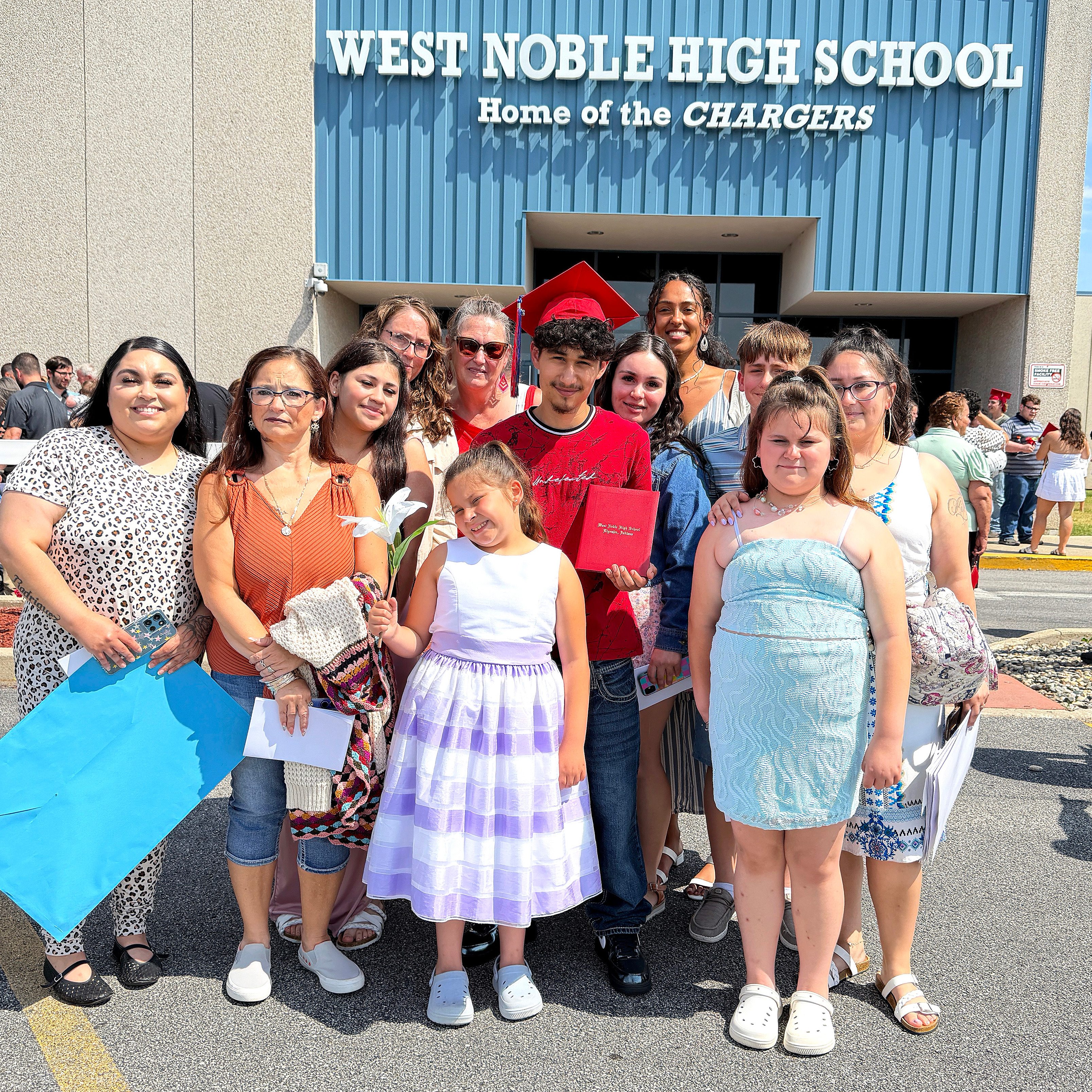 graduate with his family outside the school