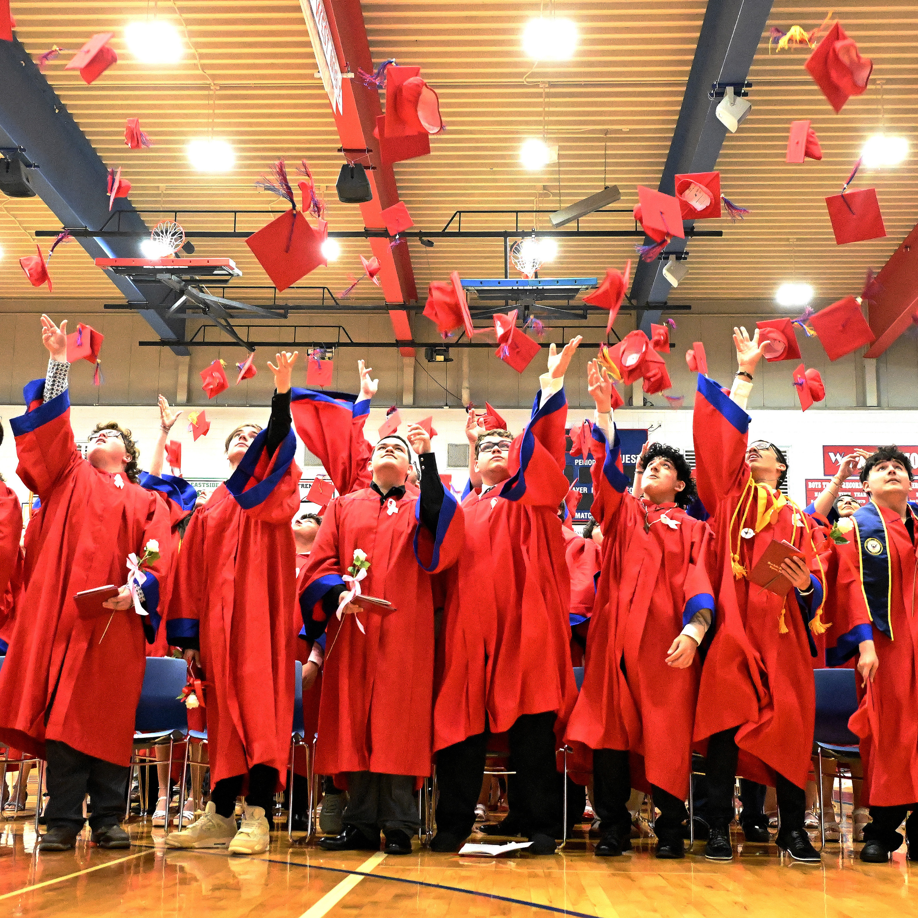 graduates tossing their caps