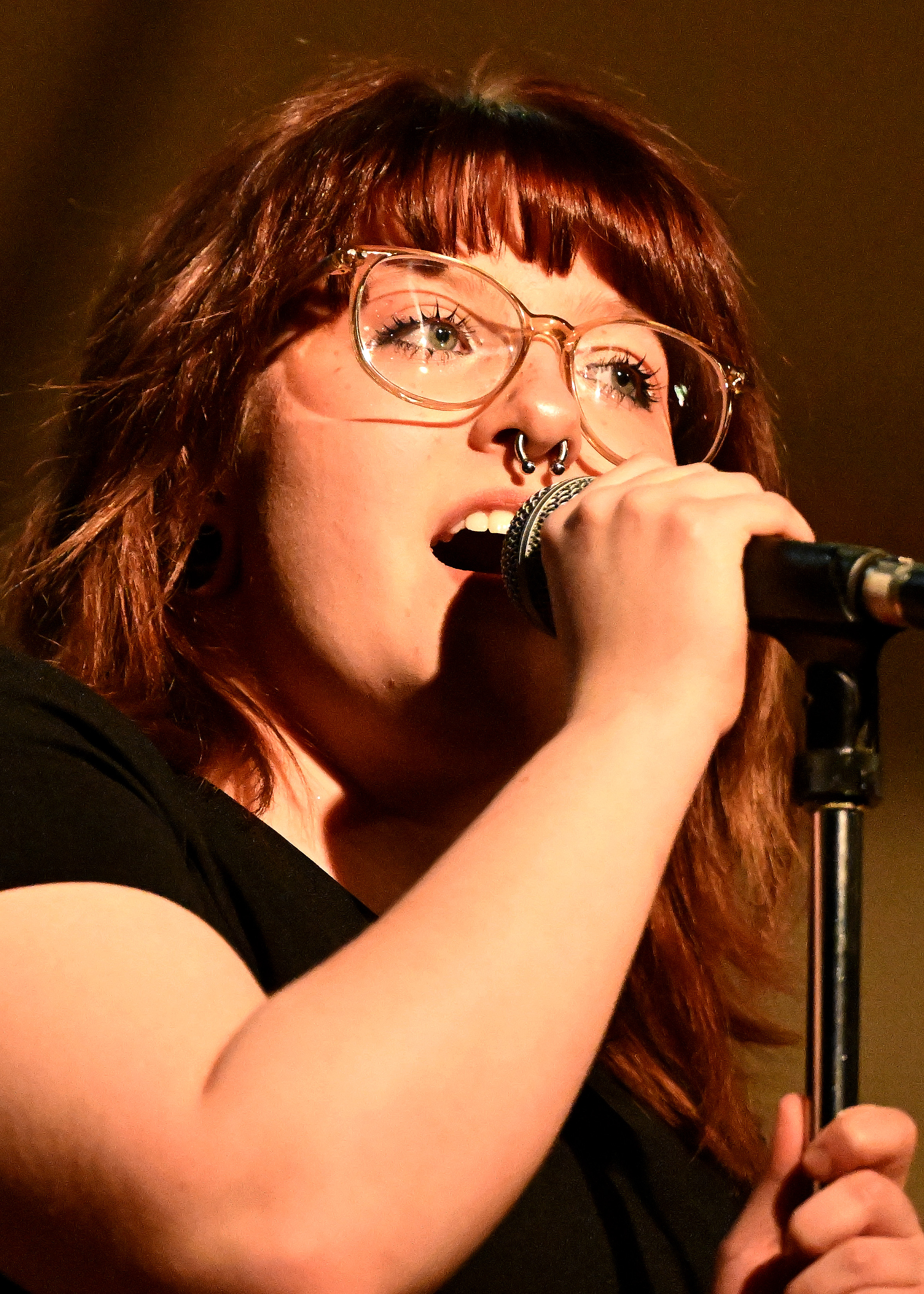a girl singing into a microphone