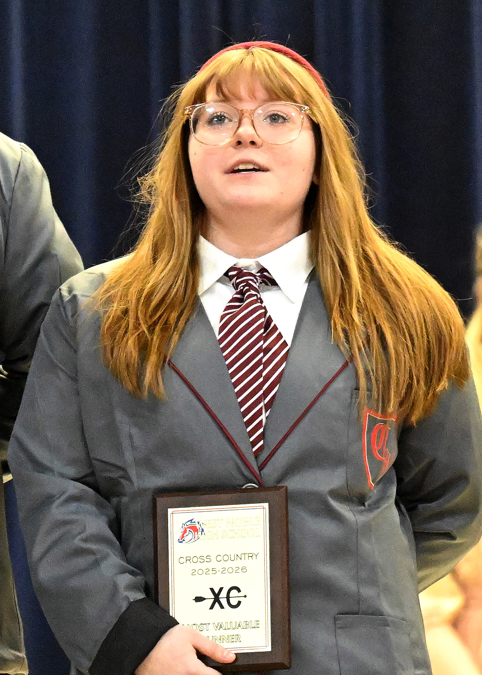 a girl in a school girl outfit singing