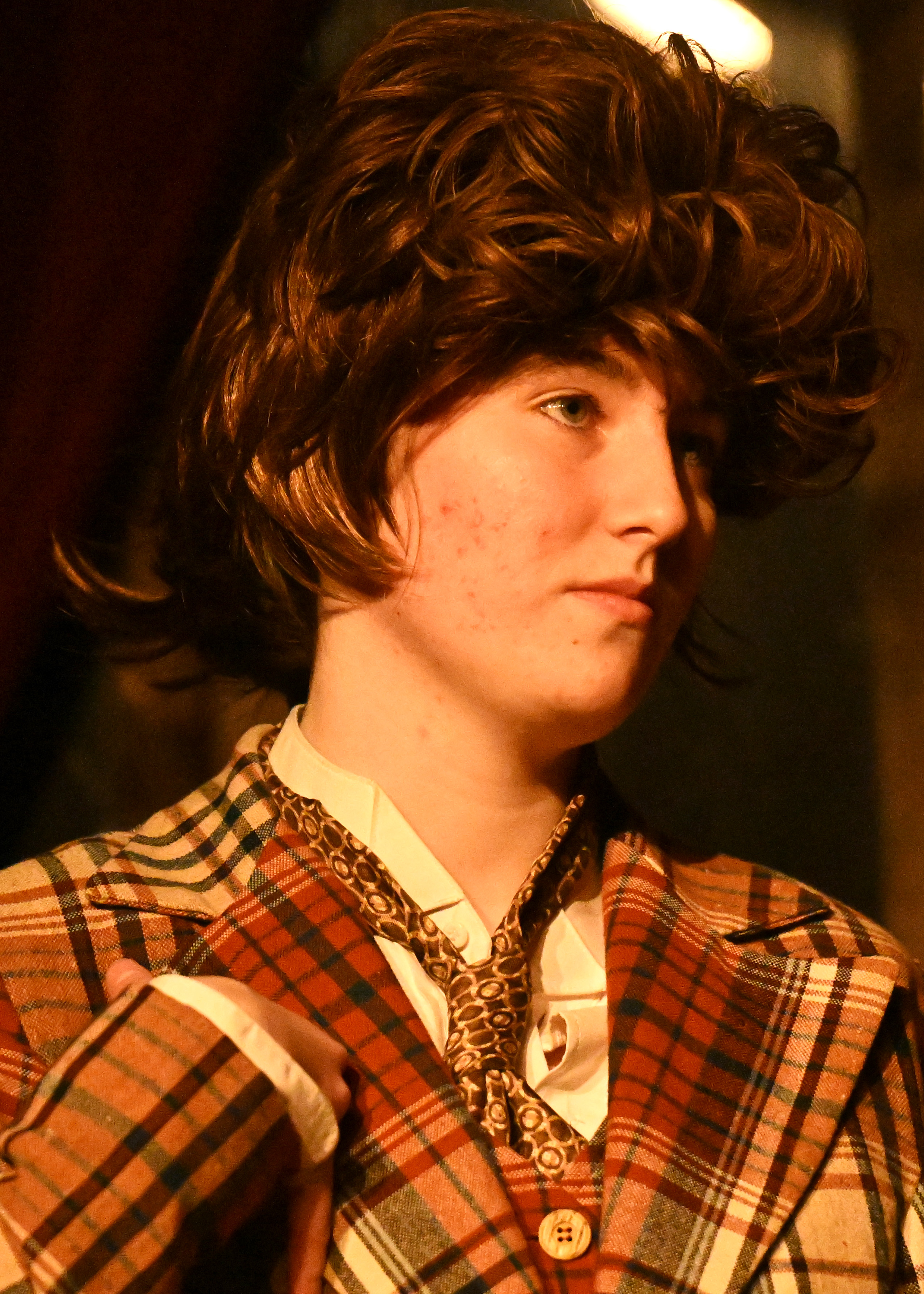 a girl in a tweed jacket and a wig
