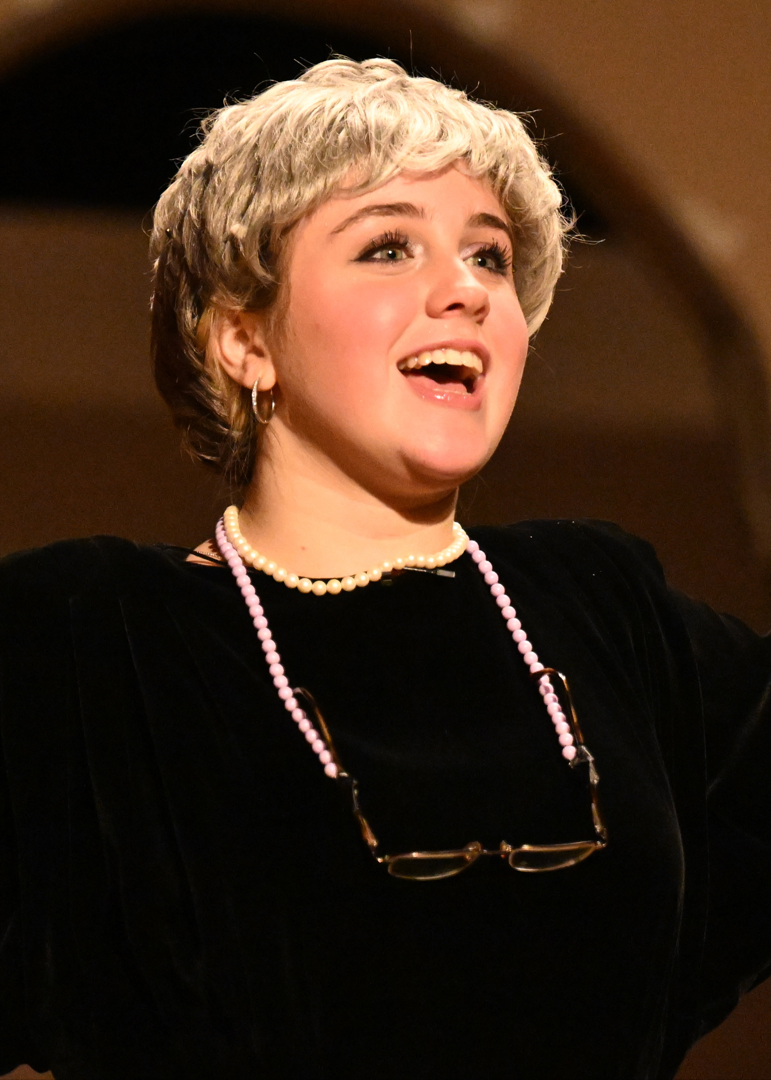 a girl in a black shirt singing