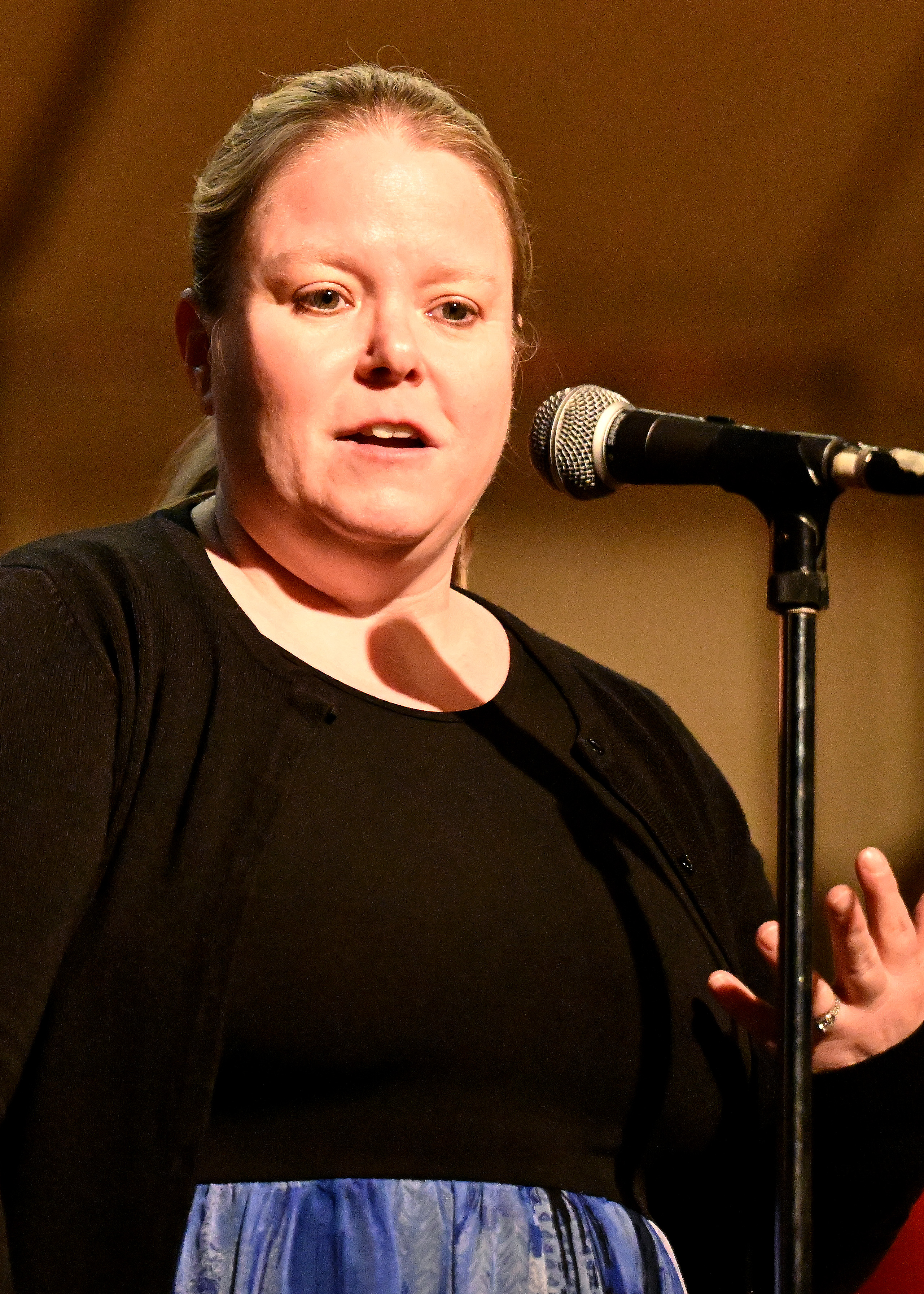 headshot of sarah sponseller talking into a microphone