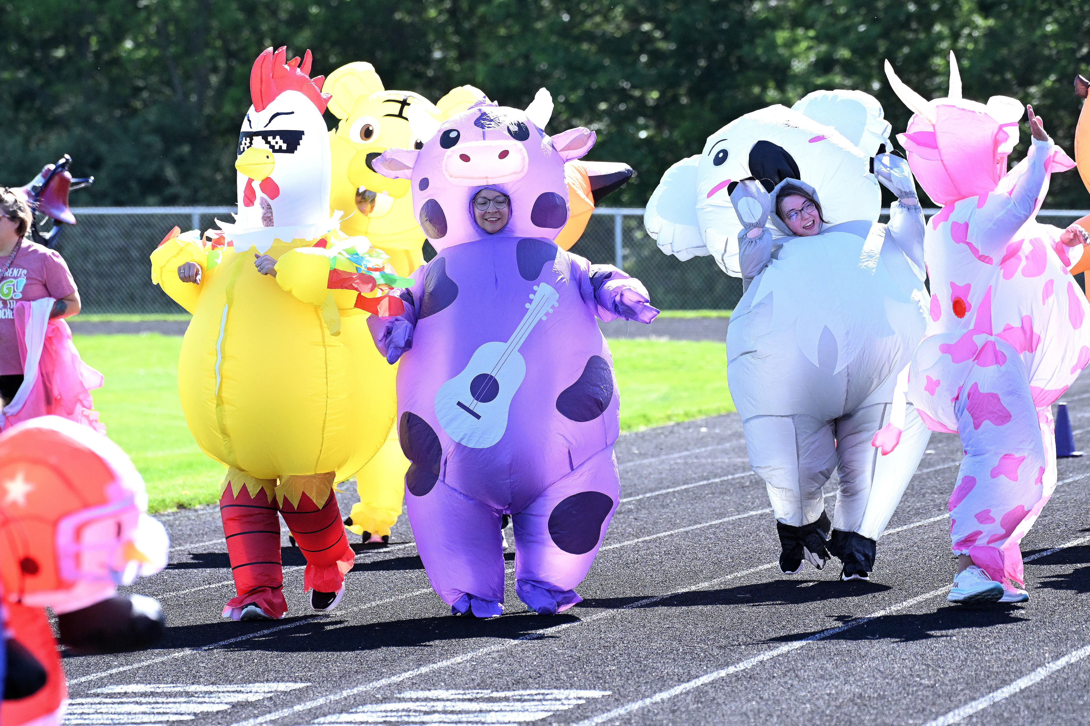 a bunch of people in inflatable costumes