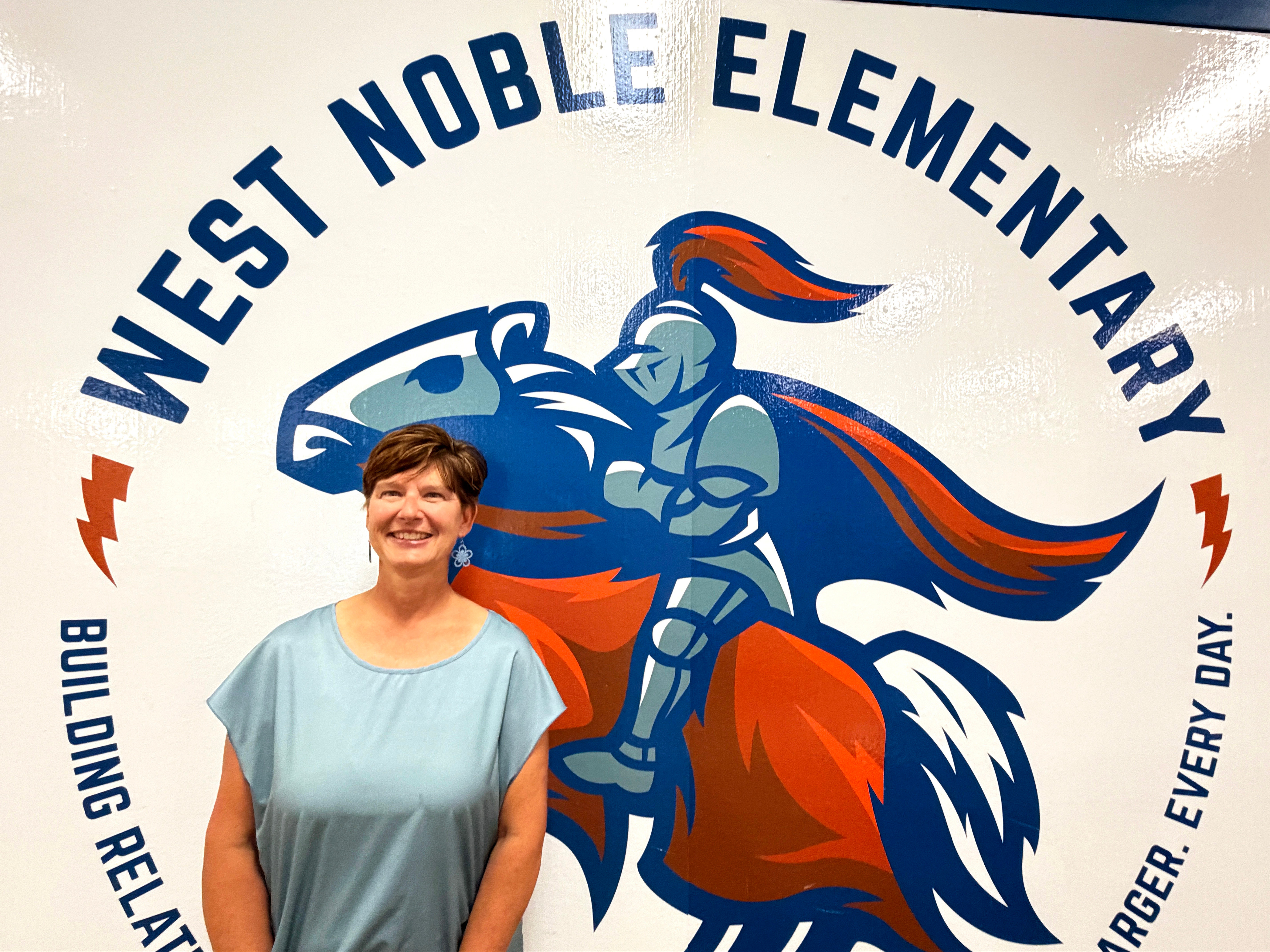 jennifer duncan in front of the mural at wnes