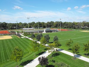 A panoramic view showcasing both a baseball field and a soccer field, highlighting their distinct layouts and markings.