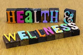 Wooden letters arranged to spell "health and wellness" on a neutral background, symbolizing a focus on well-being.